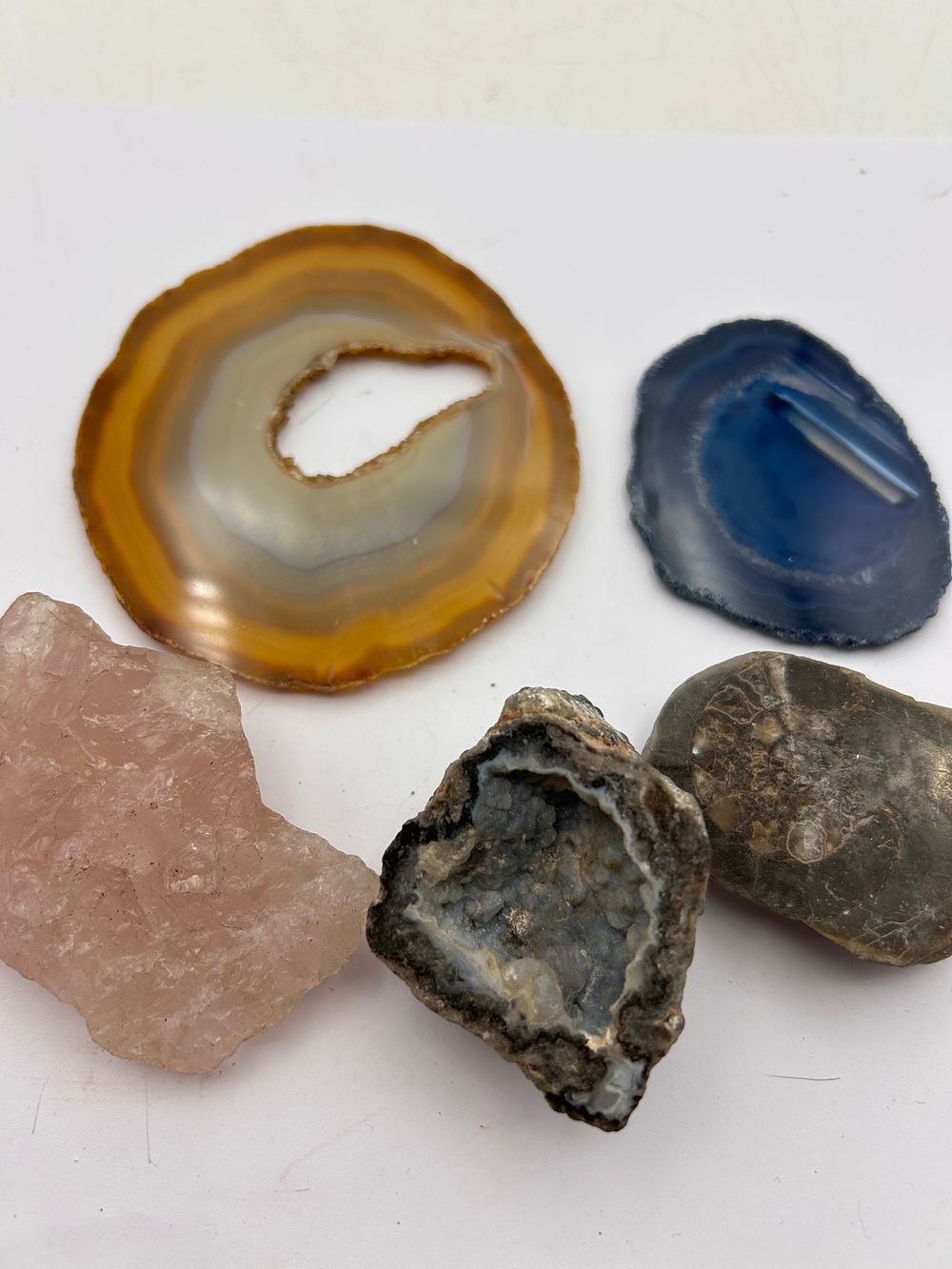 Lot 372: A Collection of Assorted Mineral Specimens, including Agate Slices, Rose Quartz, and a Geode Fragment