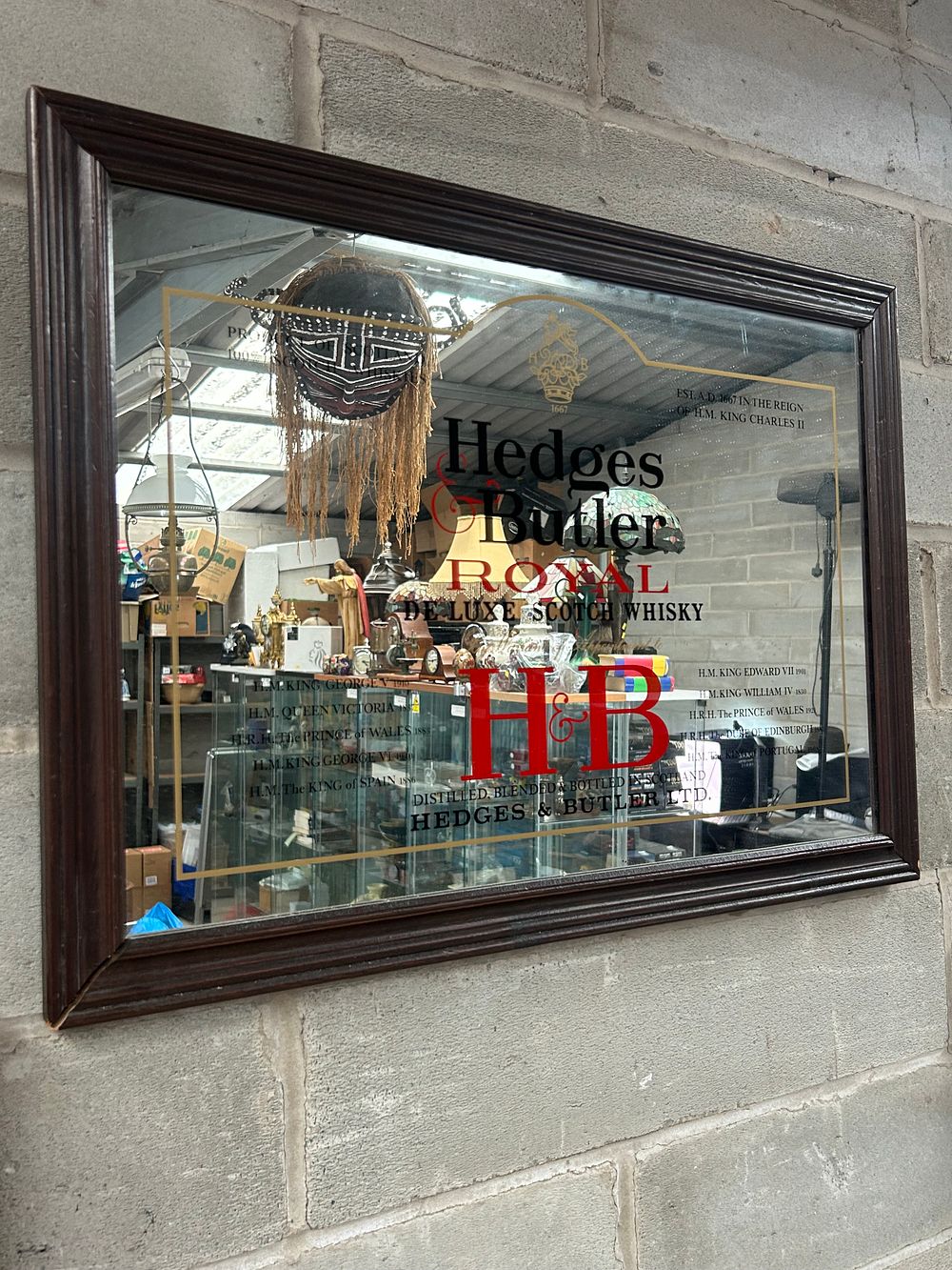 Lot 425: A Hedges & Butler 'Royal De Luxe Scotch Whisky' Advertising Mirror, Mid-20th Century. 28 x 20”