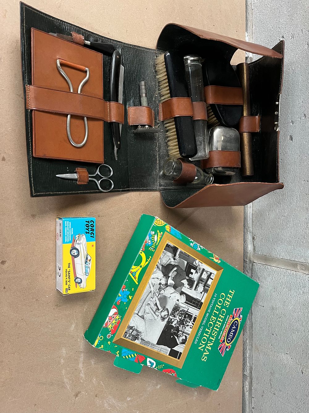 Lot 473: A Vintage Leather Travel Grooming Case, A Set of Ten Corgi Cameo 'The Christmas Collection' Vehicles, and a Corgi Toys 'The Saint's Car' Volvo P.1800 Box