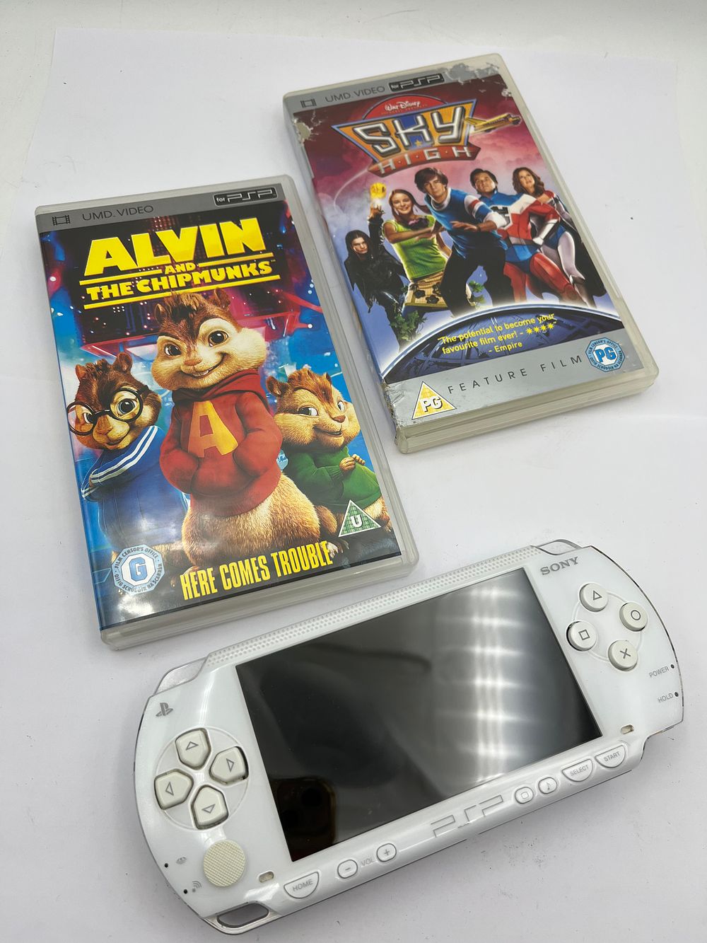 Lot 477: A Sony PSP Handheld Console with Two UMD Video Discs
