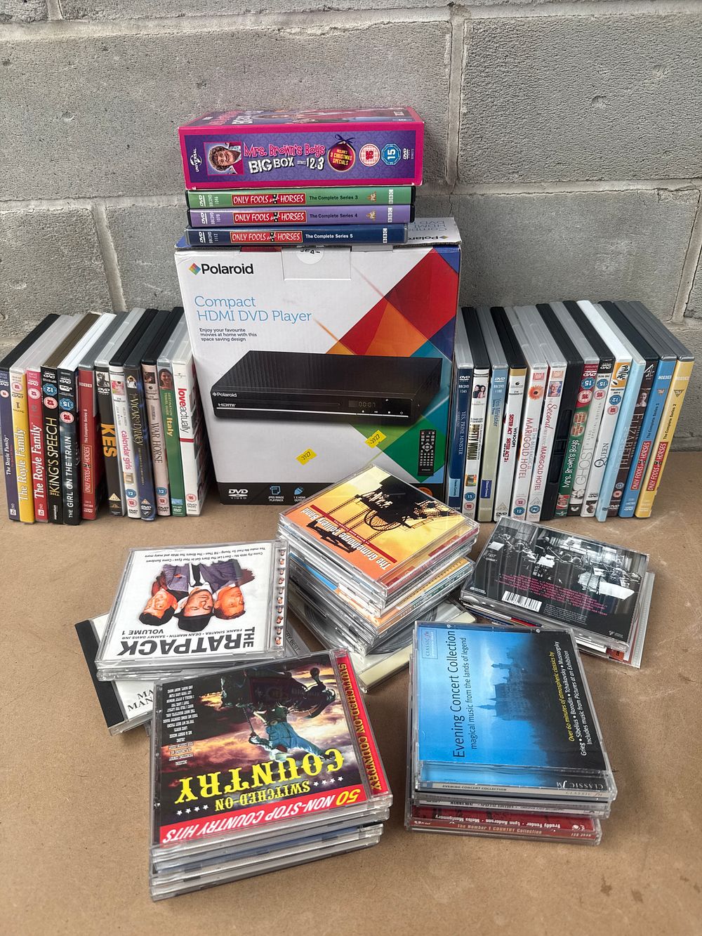 Lot 512: A Polaroid Compact HDMI DVD Player, with a Collection of DVDs and CDs