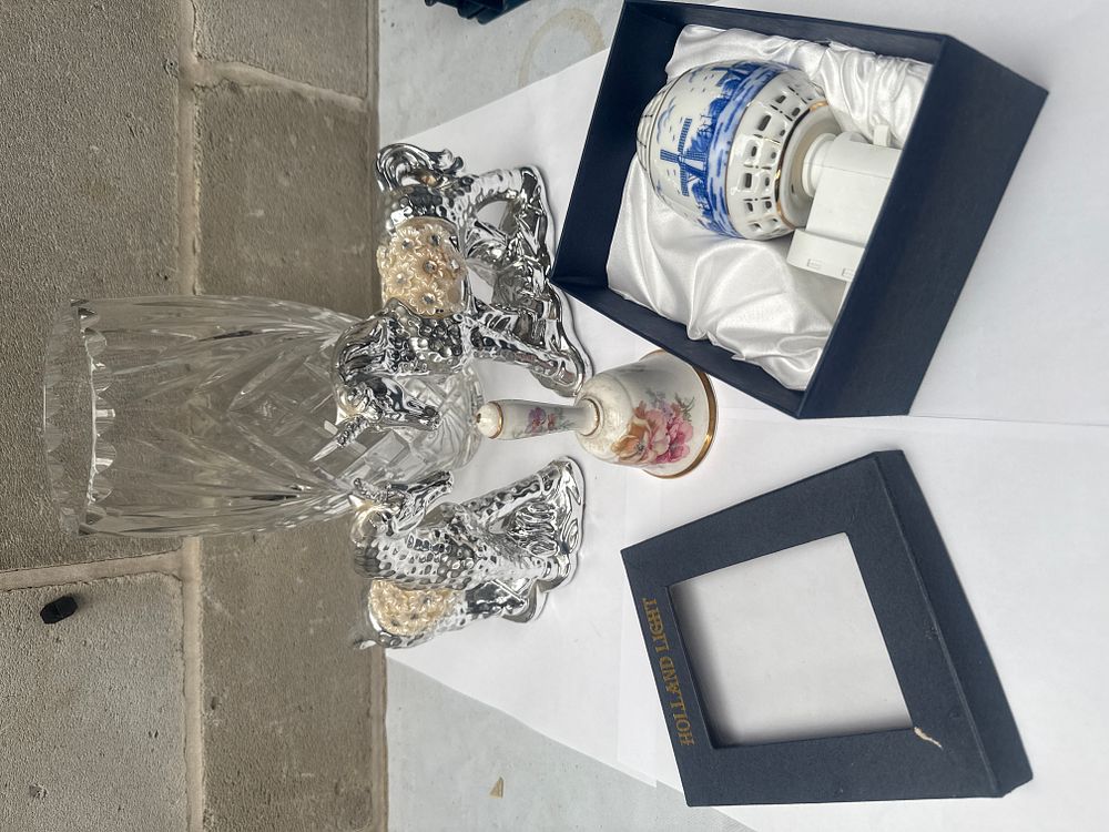 Lot 577: A Collection of Decorative Objects, including a Cut Lead Crystal Vase, a Pair of Silver-Toned Candlesticks, and a Delft-Style Ceramic Night Light