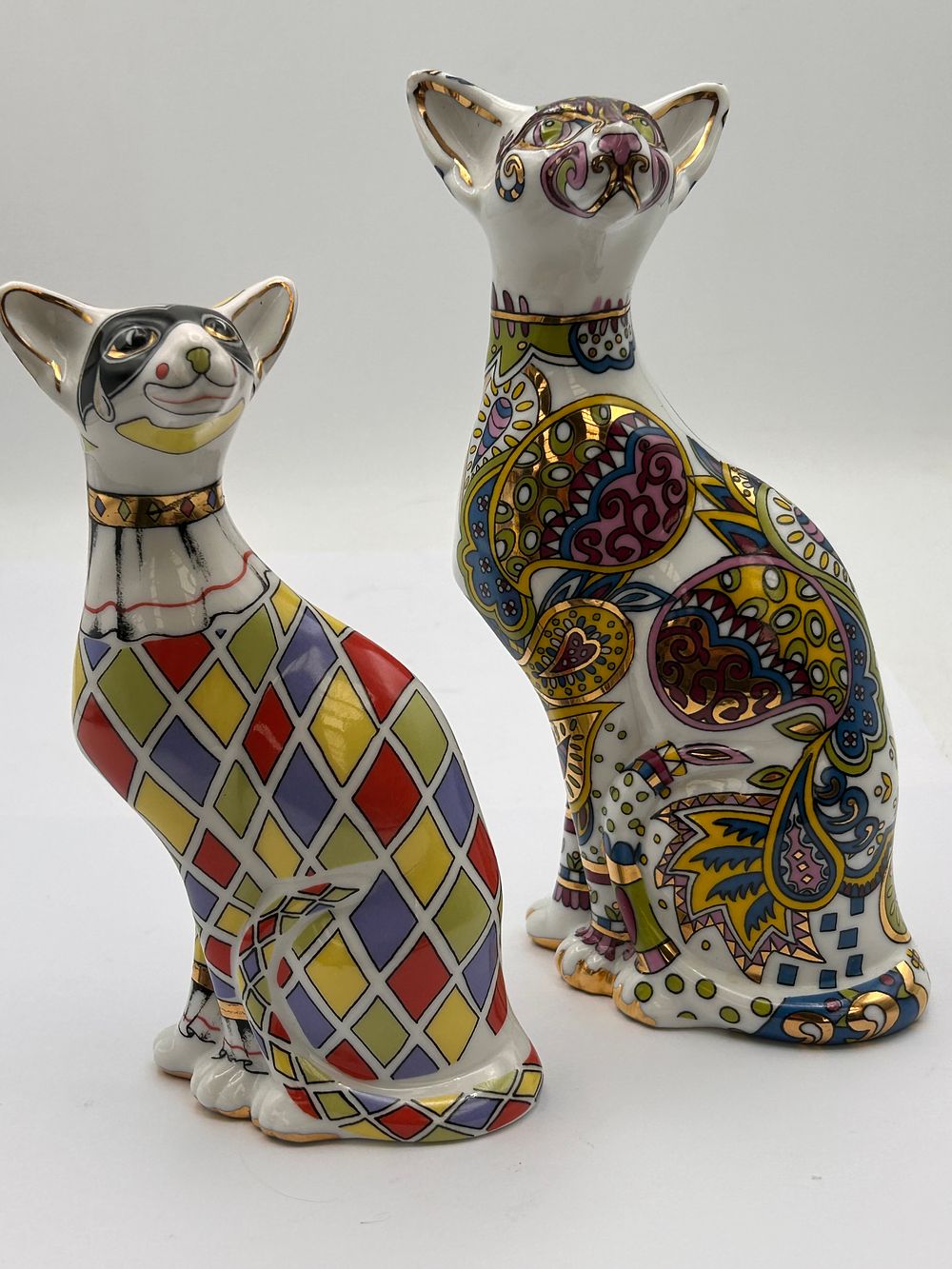 Lot 582: A Pair of Paul Cardew 'Cool Catz' Harlequin and Paisley Cat Figurines