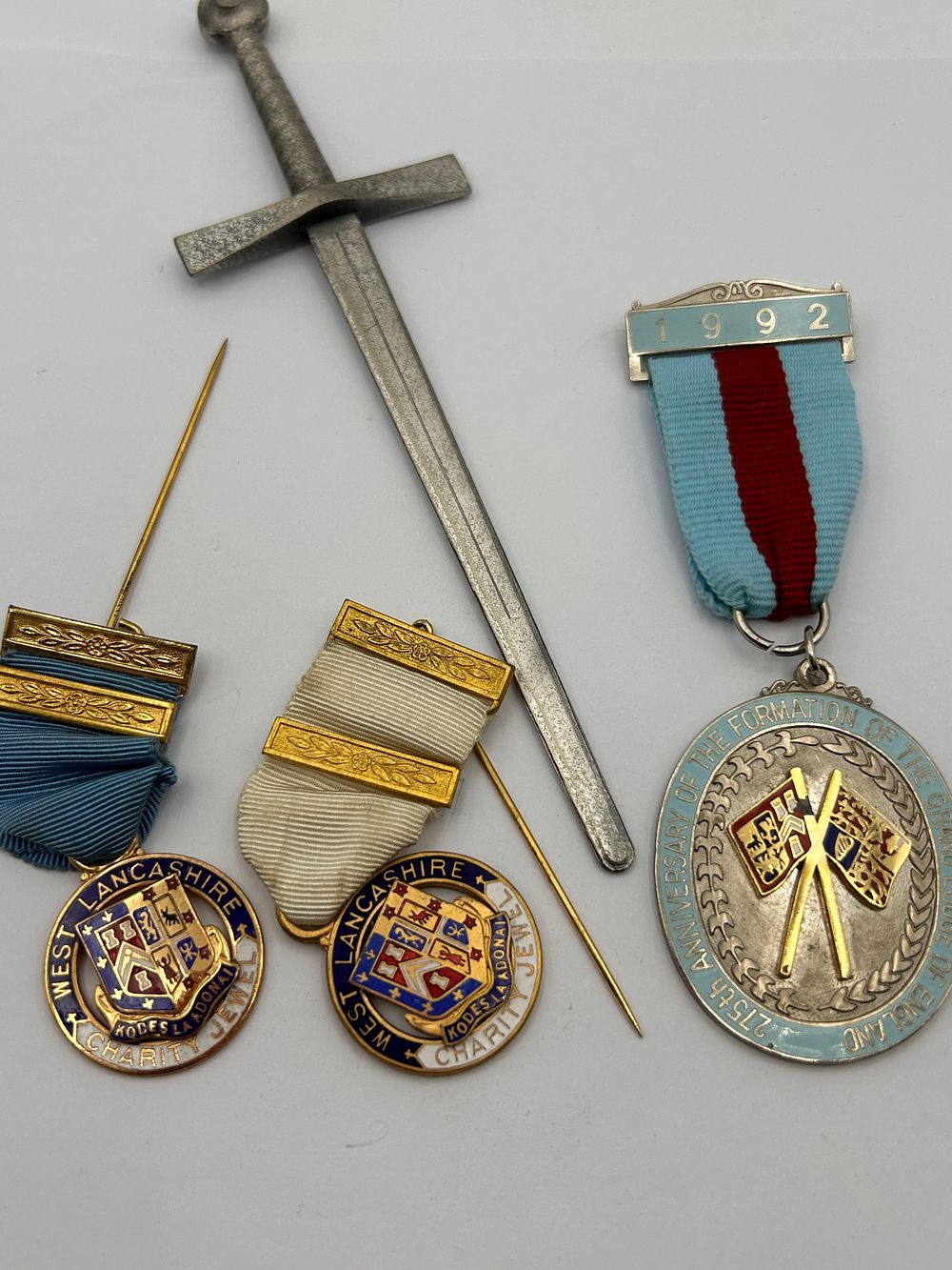 Lot 587: A Collection of Late 20th Century Fraternal and Commemorative Regalia, including Medals and a Miniature Ceremonial Sword