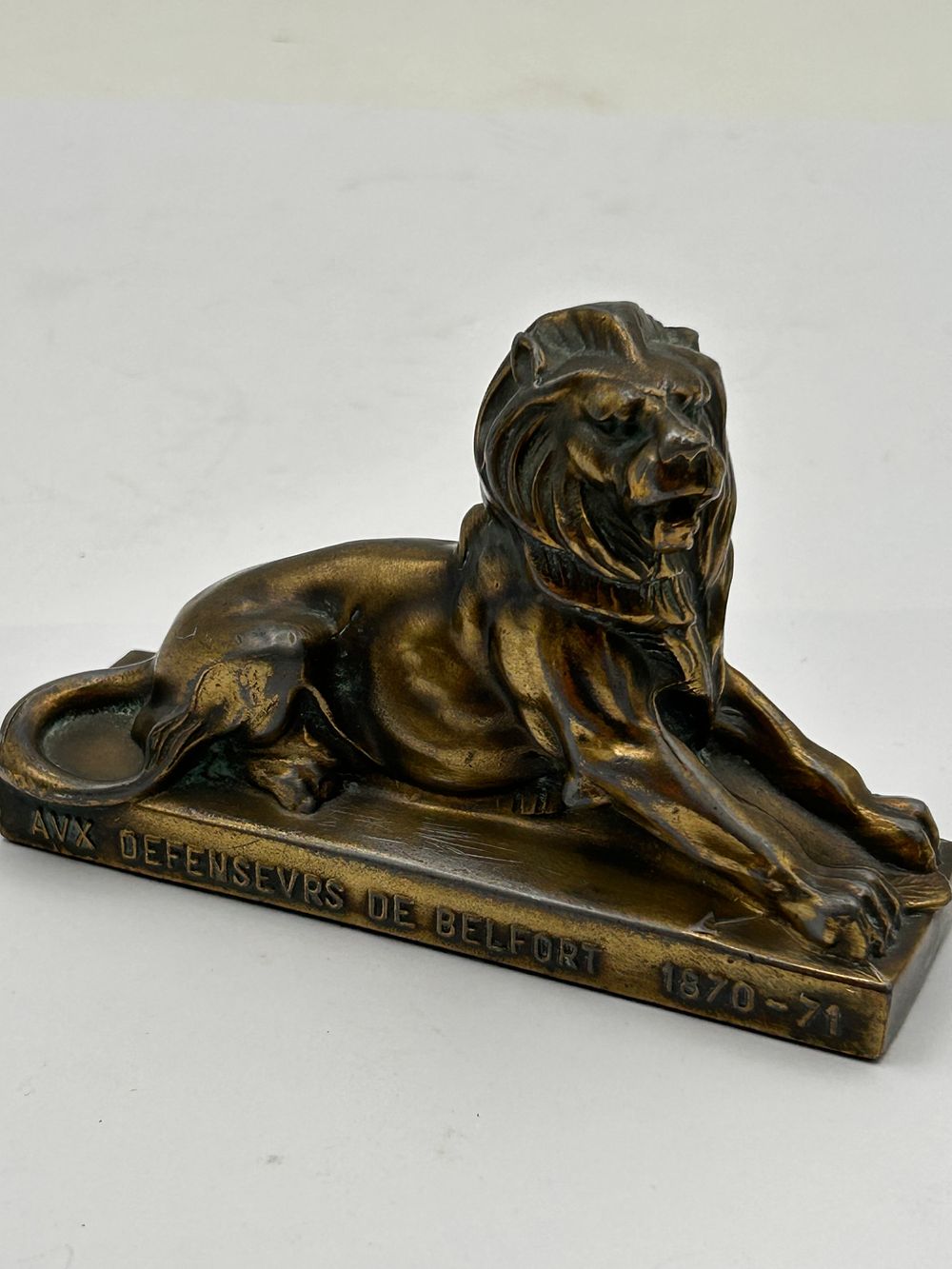 Lot 588: A Cast Metal Recumbent Lion Paperweight, Commemorating the Defenders of Belfort 1870-71