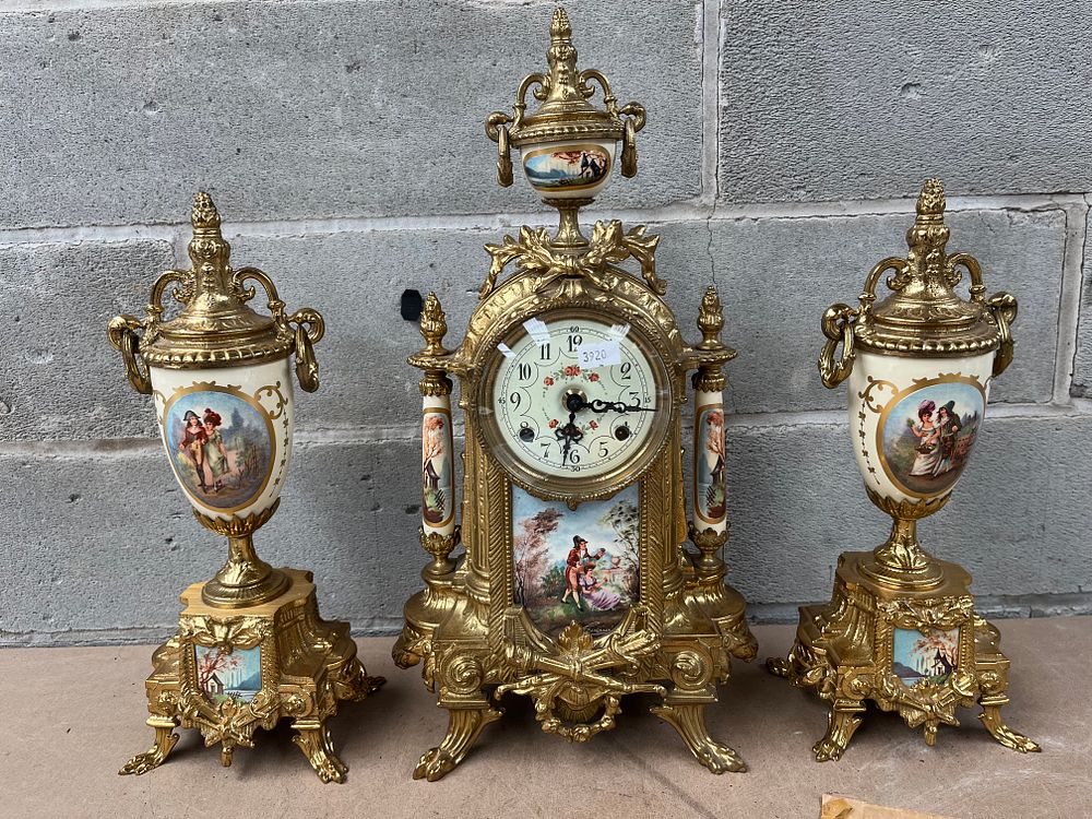 Lot 612: A Three-Piece Franz Hermle Gilt-Metal and Porcelain Garniture Clock Set, French Style