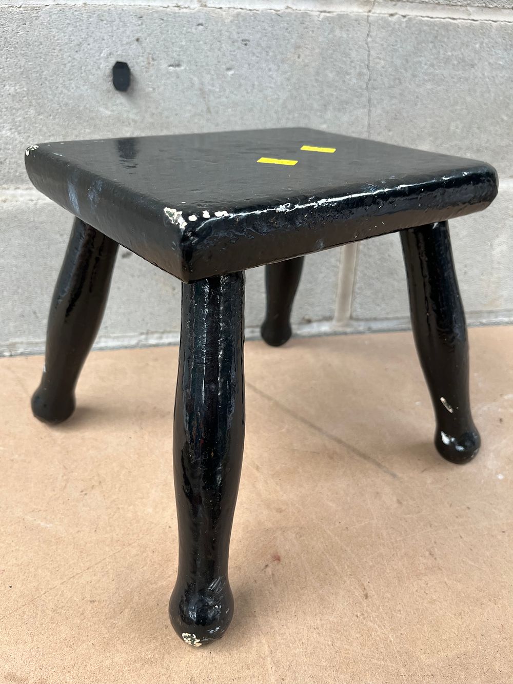 Lot 621: A Primitive Black Painted Wooden Stool