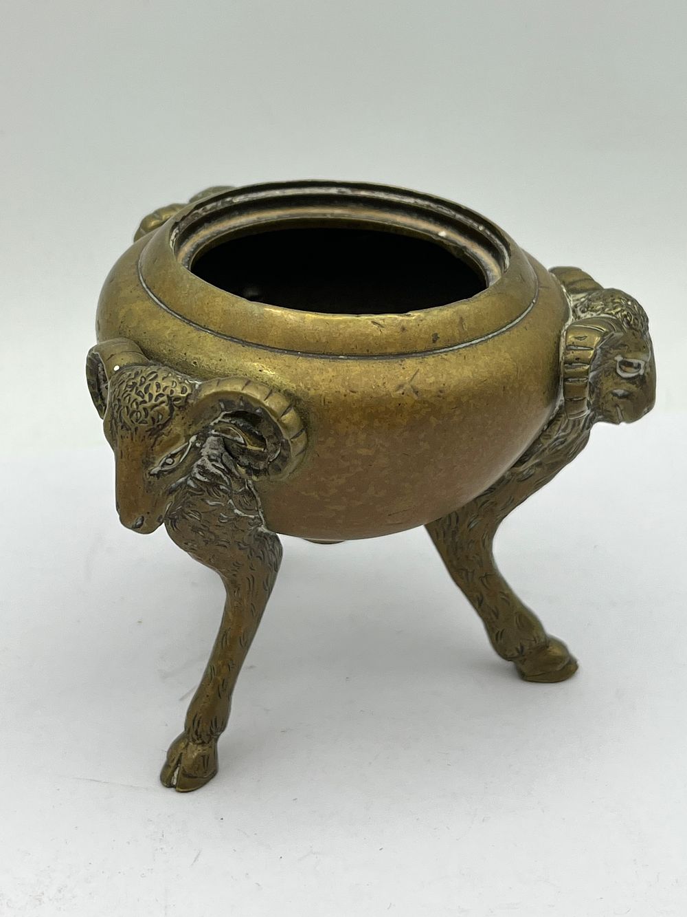 Lot 624: An Antique Chinese Bronze Tripod Censer with Ram's Head Legs