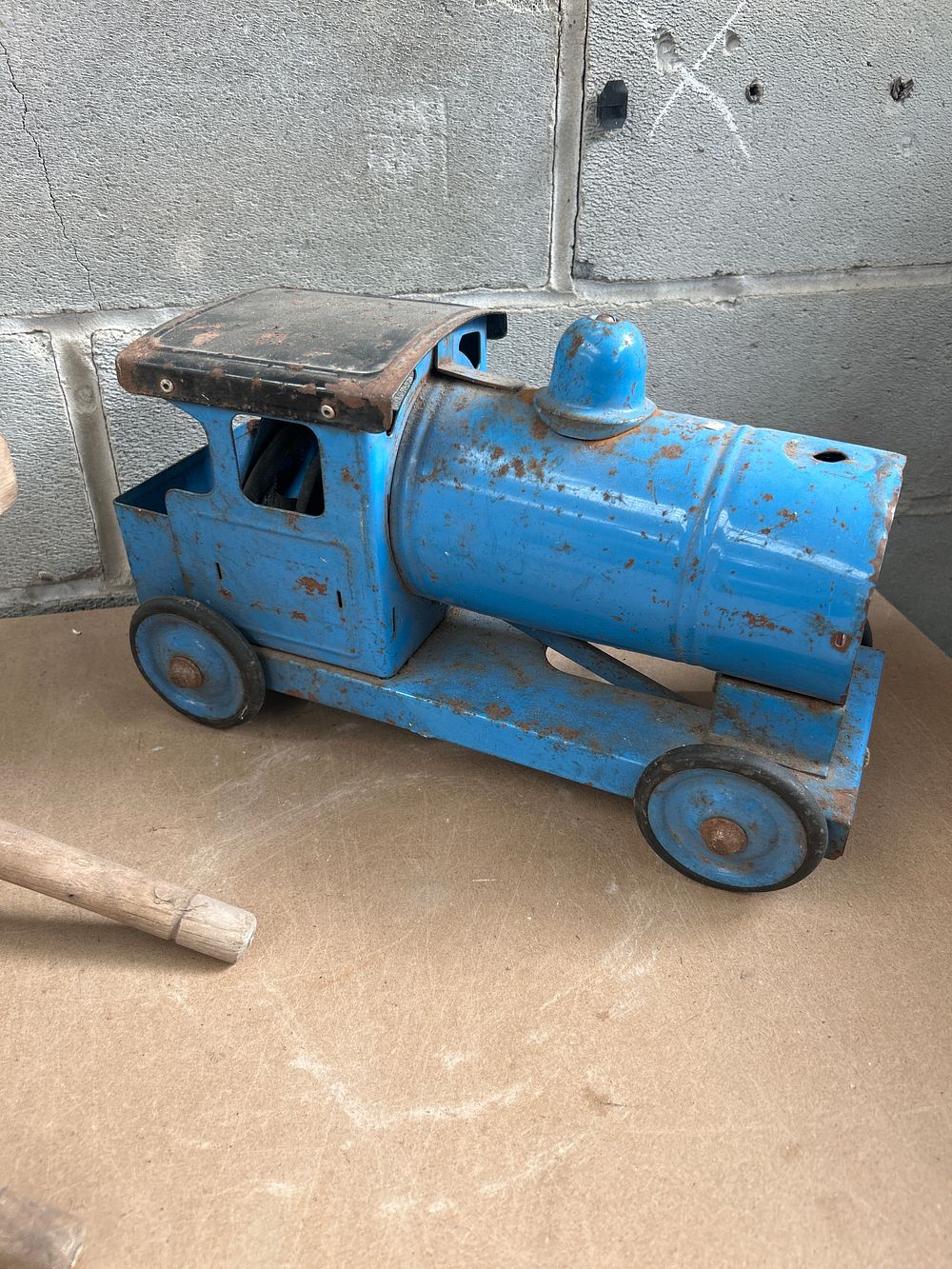 Lot 657: A Tin Plate Toy Train Engine and a Wooden Toy Wheelbarrow