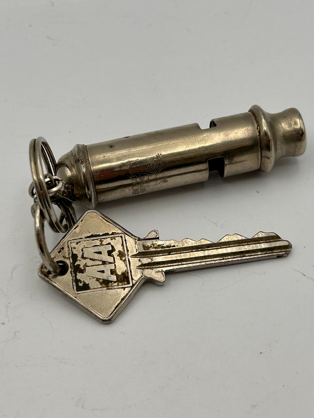 Lot 242: A Whistle Engraved 'Hong Kong' and an AA Key