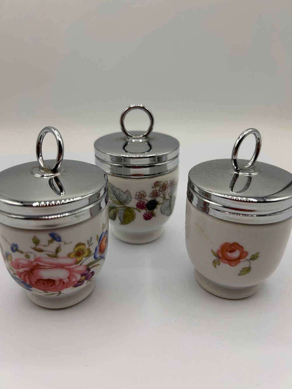 Lot 304: Three Royal Worcester Vitreous Porcelain Egg Coddlers, Various Floral Patterns