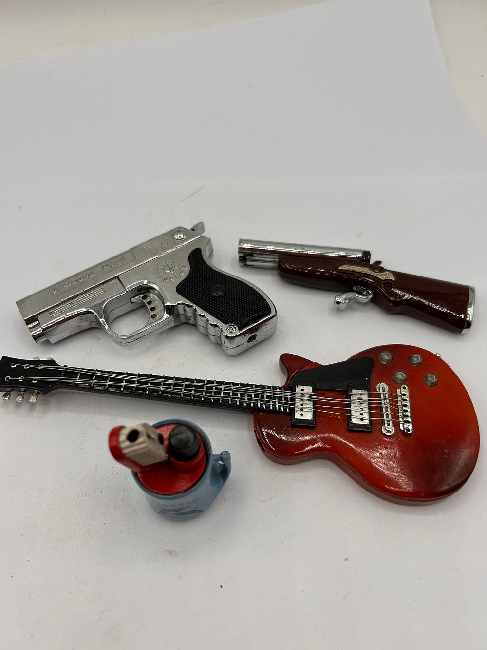 Lot 310: A Group of Four Late 20th Century Novelty Butane Lighters