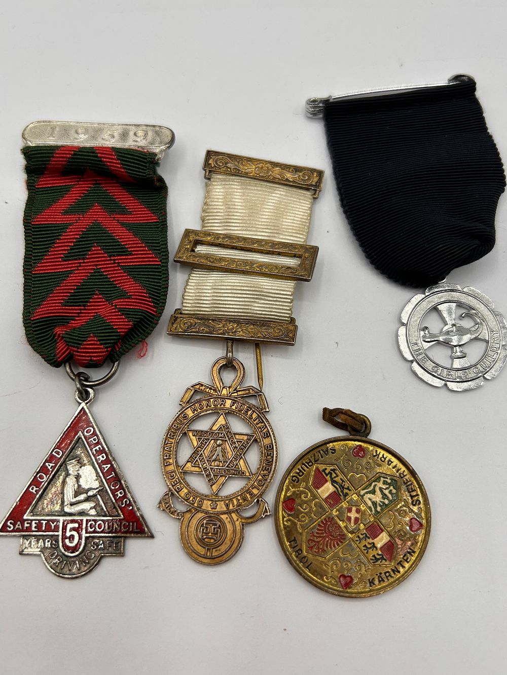 Lot 312: A Collection of Vintage Medals and Badges, including a Road Operators Safe Driving Medal and an 1894 Masonic Jewel