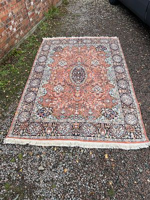 A Vintage Turkish Hand-Knotted Oriental Rug, 113 x 71.5”. A rectangular hand-knotted textile rug 