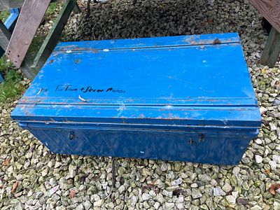 A Large Blue Painted Metal Hinged-Lid Storage Trunk, 35” Wide. A rectangular, hinged-lid metal 