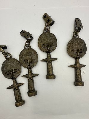 A Group of Four Brass Ashanti Fertility Doll. A group of four stylized figurative pendants 