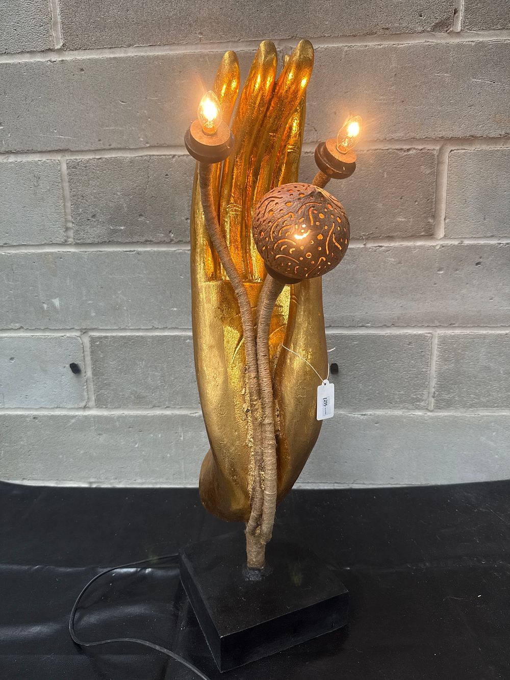 Lot 403: A Decorative Gold-Finished Hand Sculpture Table Lamp with Coconut Shell Shade, 26” Tall