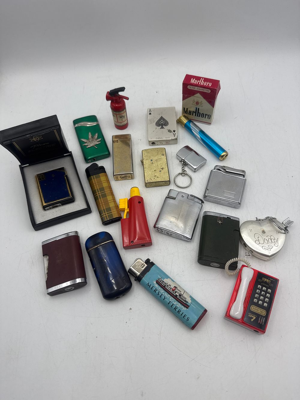 Lot 404: A Collection of 19 Lighters and Novelty Lighter Items, including Zippo and Ronson