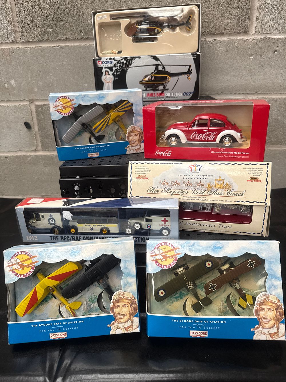 Lot 405: A Collection of Seven New-in-Box Die-Cast Model Collectibles, including Corgi James Bond, Coca-Cola Volkswagen Beetle, and Royal Anniversary Coach