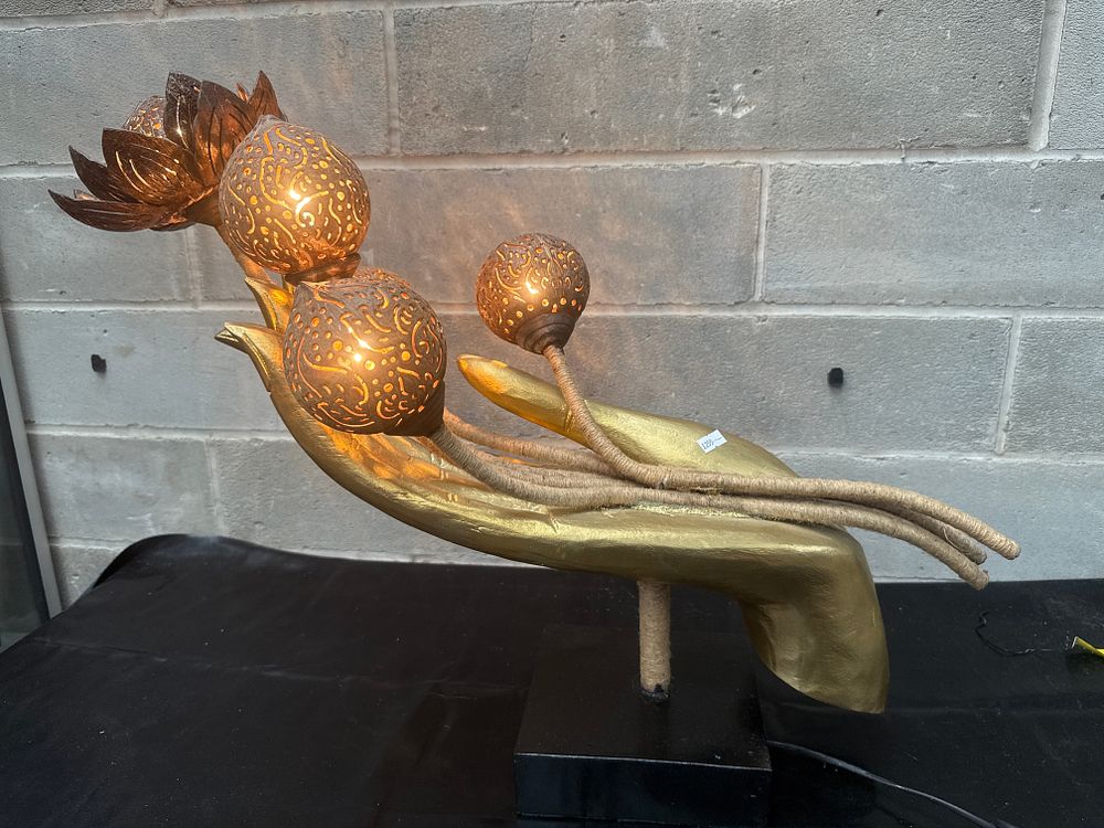 Lot 420: A Contemporary Gilt-Finished Illuminated Hand Sculpture with Carved Coconut Shell Lotus Elements