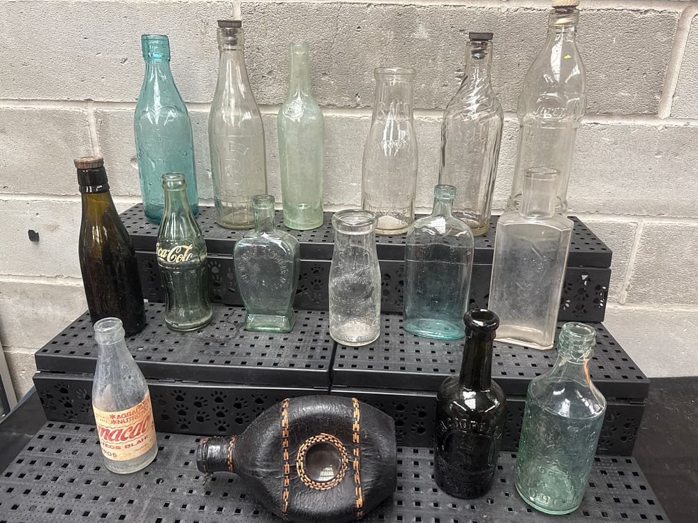 Lot 425: A Collection of Sixteen Antique and Vintage Glass Bottles and a Leather-Wrapped Flask