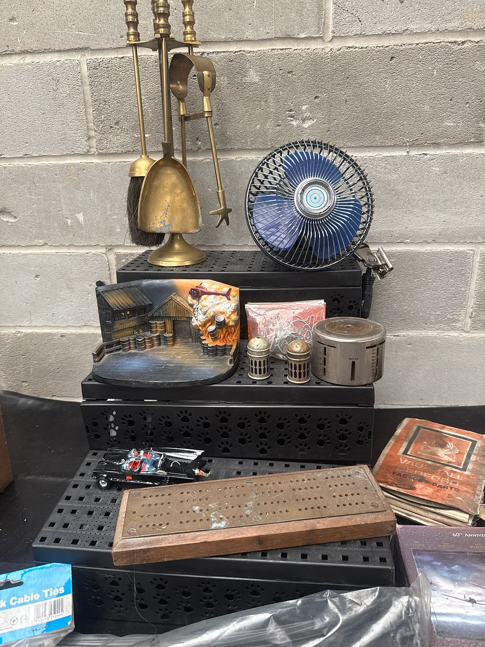 Lot 447: A Mixed Lot of Collectables and Household Items, including a Brass Fireplace Set, 1960s-Style Batmobile Toy, and Vauxhall Bedford Factory Parts Manual
