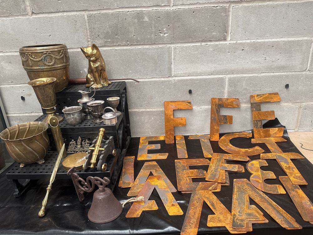 Lot 460: A Varied Collection of Decorative Metallic Objects, Industrial Iron Letters, and a Brass Wall Sconce