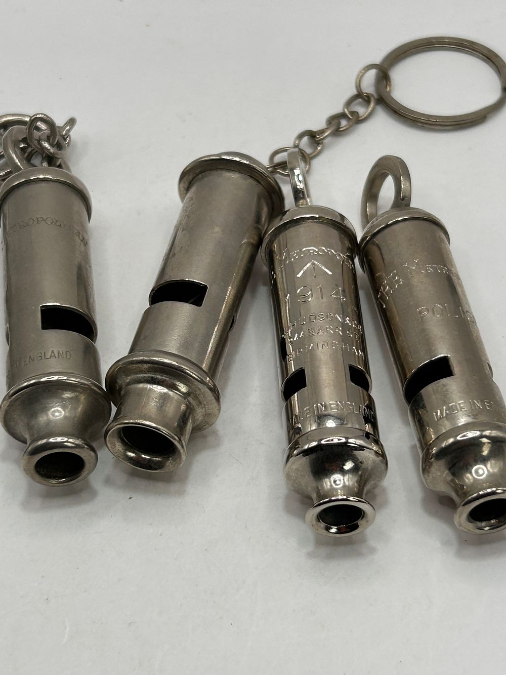 Lot 304: A Collection of Four ACME/Hudson Metropolitan Police Whistles