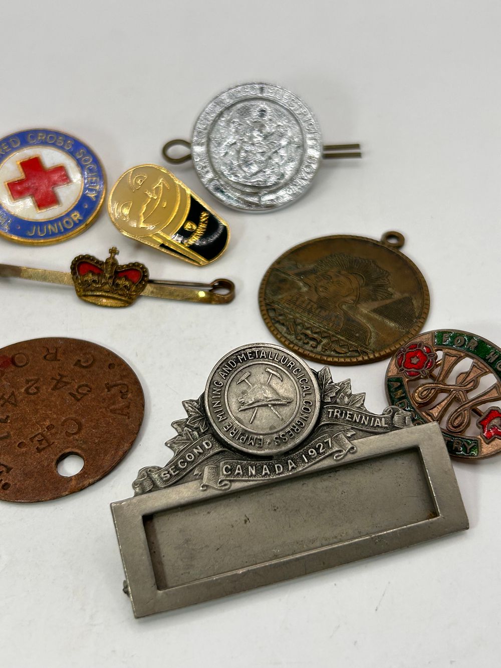 Lot 348: A Collection of Eight Vintage Badges, Medals, and Pins
