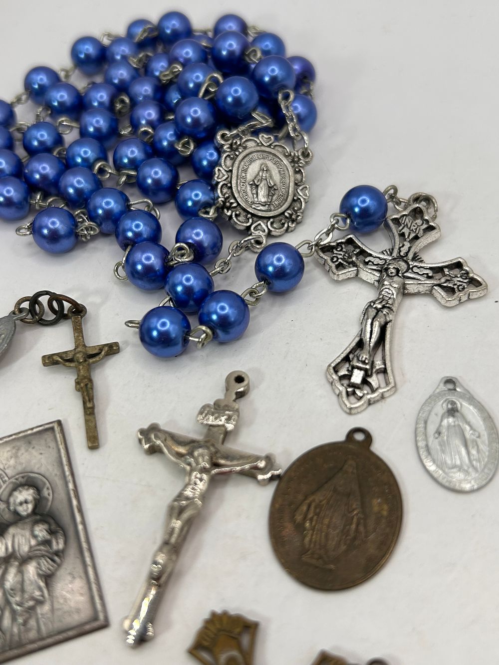 Lot 352: A Collection of 8 Devotional Items Including a Blue Faux Pearl Rosary and Assorted Medals