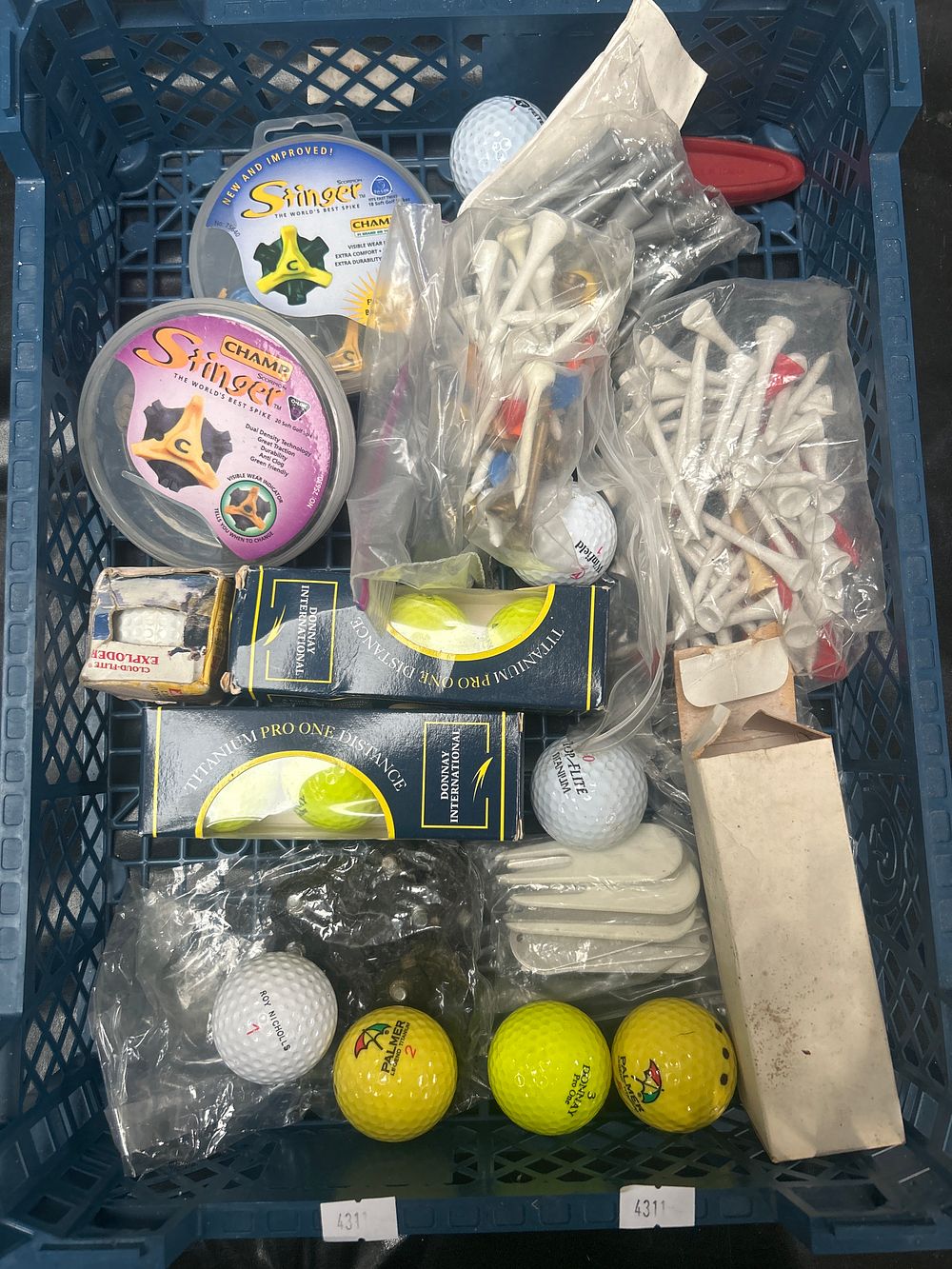 Lot 562: A Collection of  Packaged and Loose Golf Accessories including Balls, Tees, and Champ Spikes
