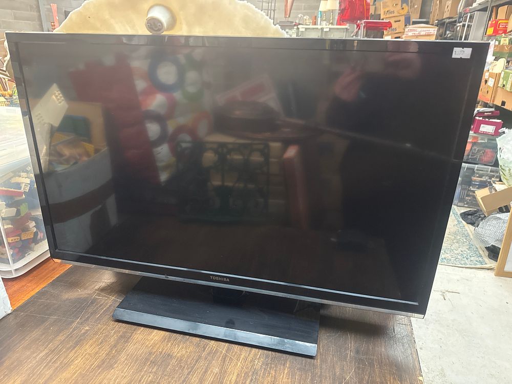Lot 505: Two Items: A Toshiba 34-Inch Flat Screen Television and a Large 23-Inch Shell