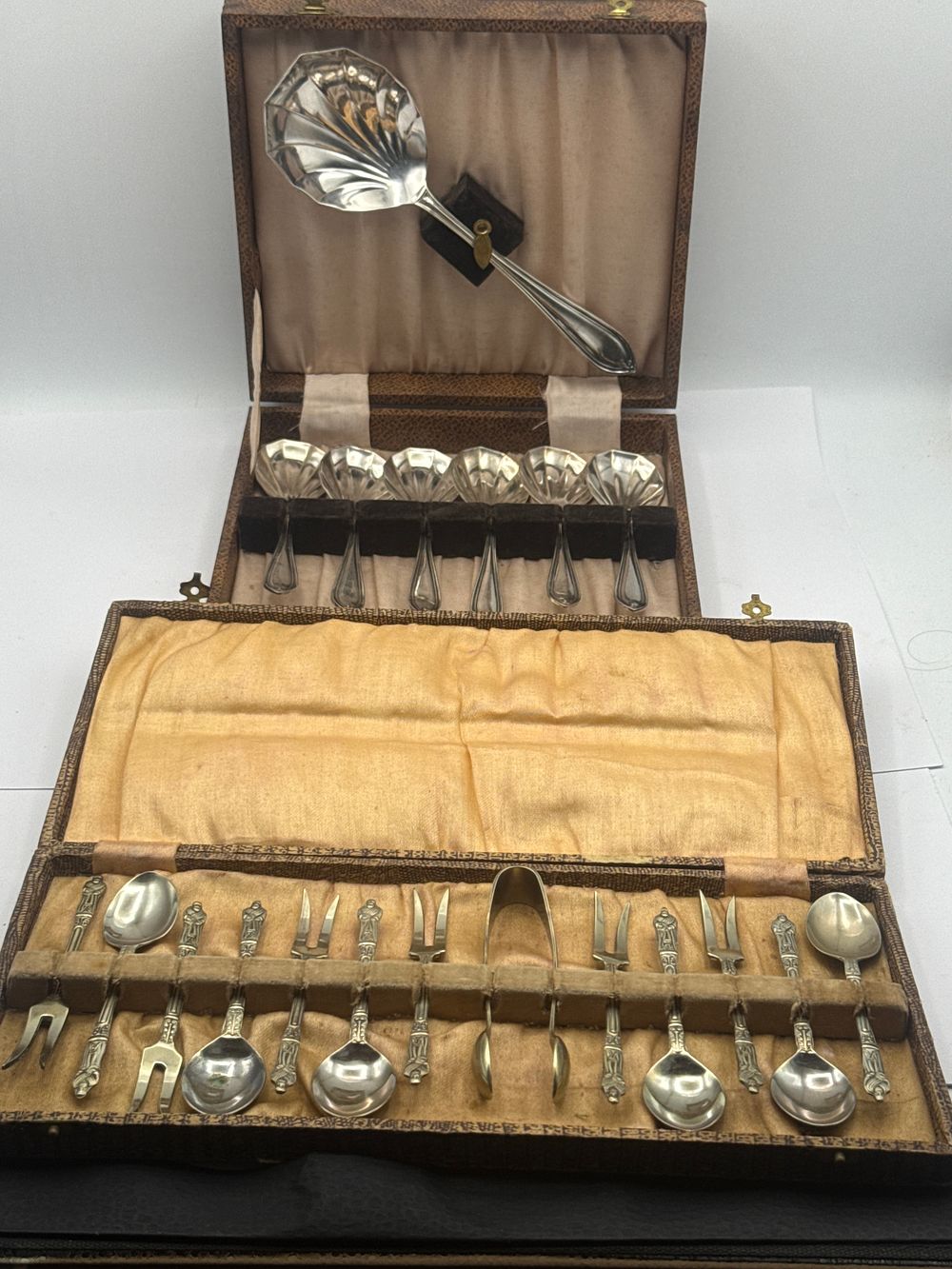 Lot 541: Two Cased Sets of Silver-Toned Flatware Including Shell-Pattern and Figural Service Pieces