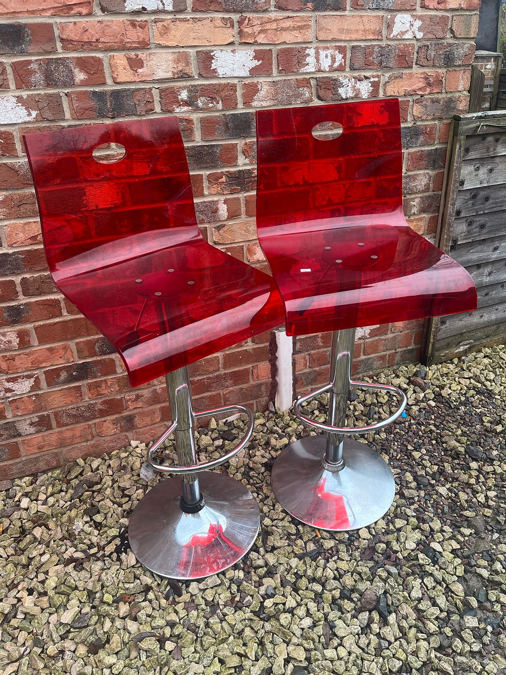 Lot 545: A Pair of Contemporary Red Acrylic and Chrome Bar Stools