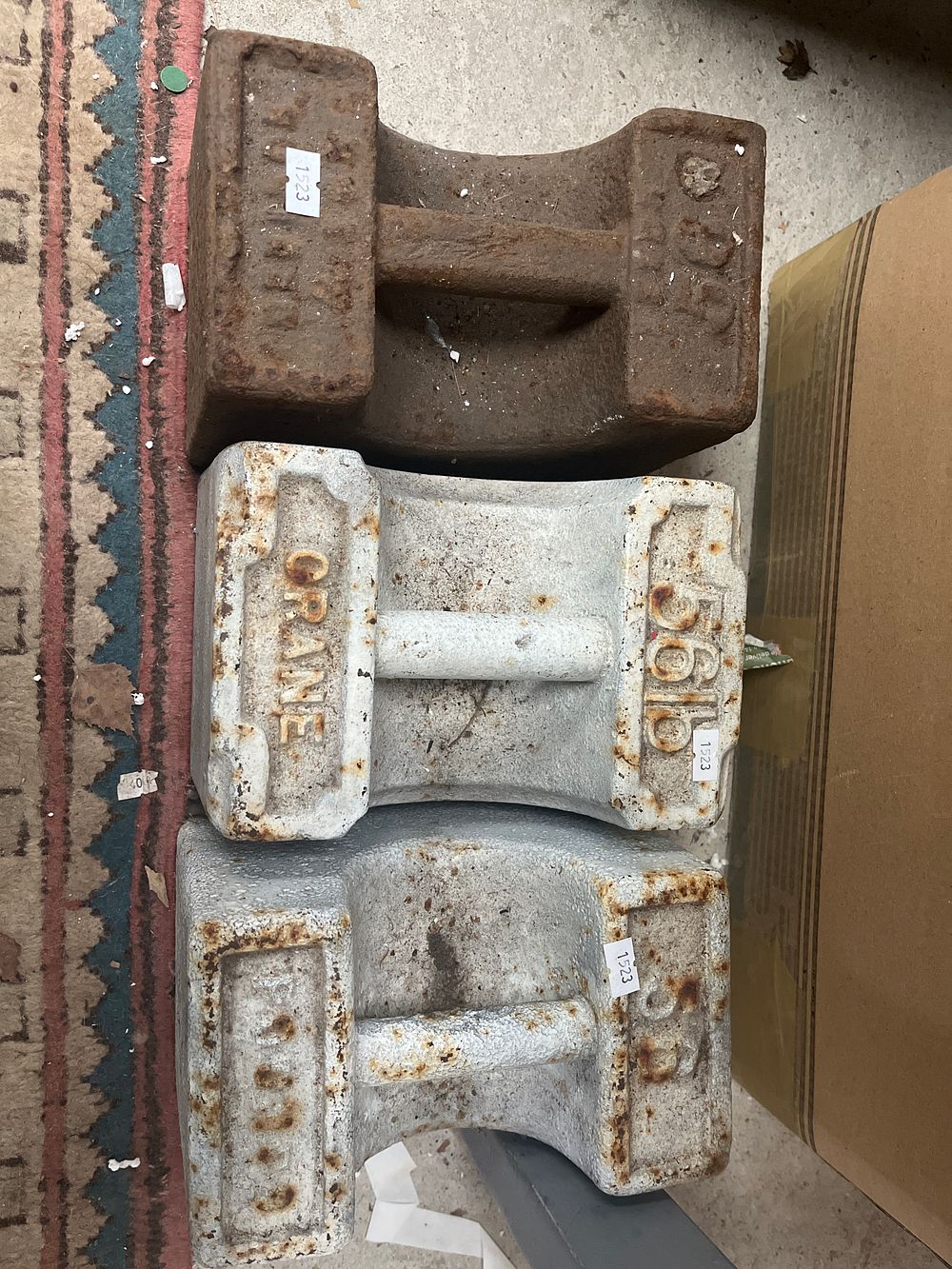 Lot 550: Three Cast Iron 56lb Industrial Trade Weights by Crane and W & T Avery