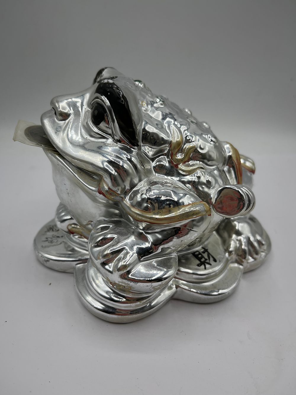 Lot 293: A 5” x 6” Silver-Toned Metallic Finished Ceramic Three-Legged Money Toad Coin Bank
