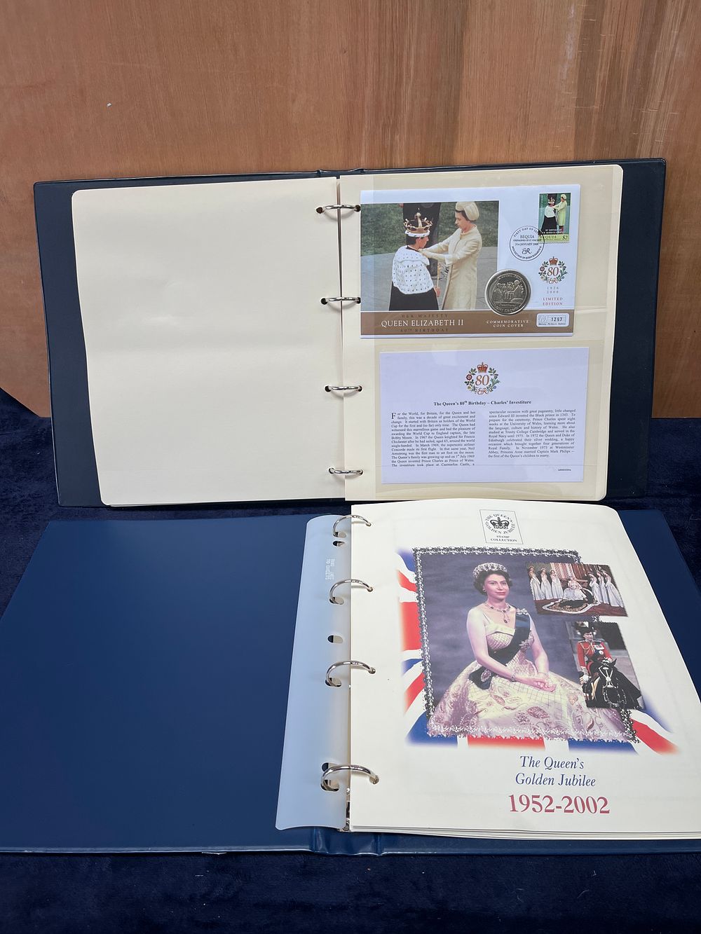 Lot 323: A Pair of Queen Elizabeth II Commemorative Coin and Stamp Albums