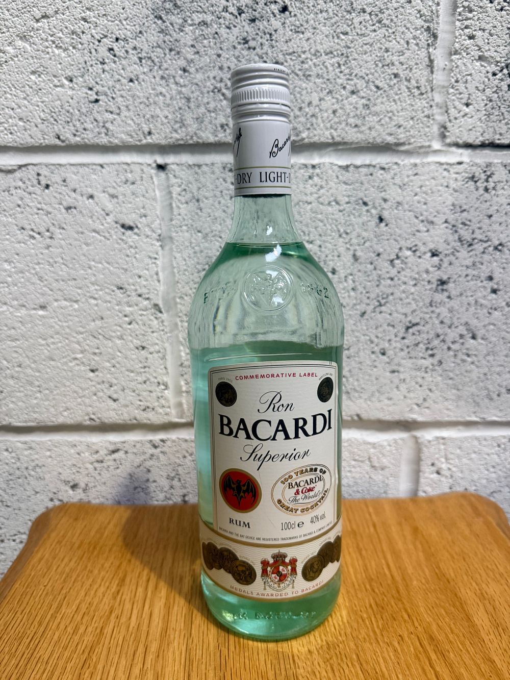 Lot 354: Bacardi Superior White Rum 100 Years of Bacardi and Coke Commemorative Label 1L