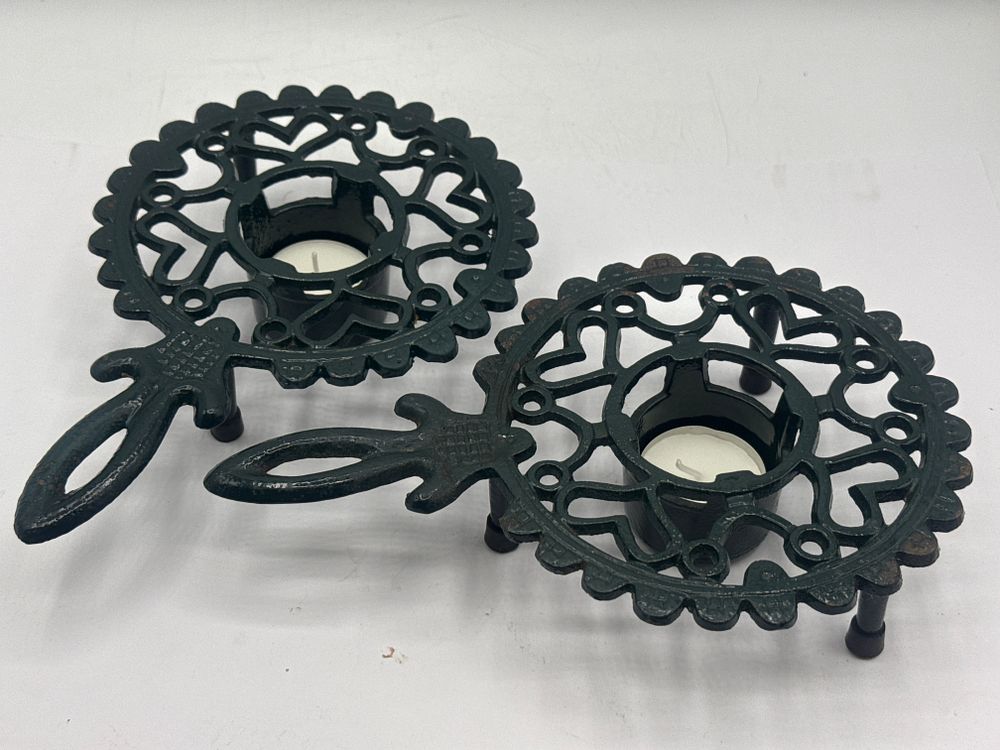 Lot 366: A Pair of Wilton Cast Iron Heart Pattern Teapot Warmers