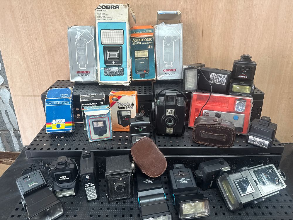 Lot 406: An Assortment of Vintage Camera Flashes and Photography Equipment including Vivitar, Cobra, and Helios