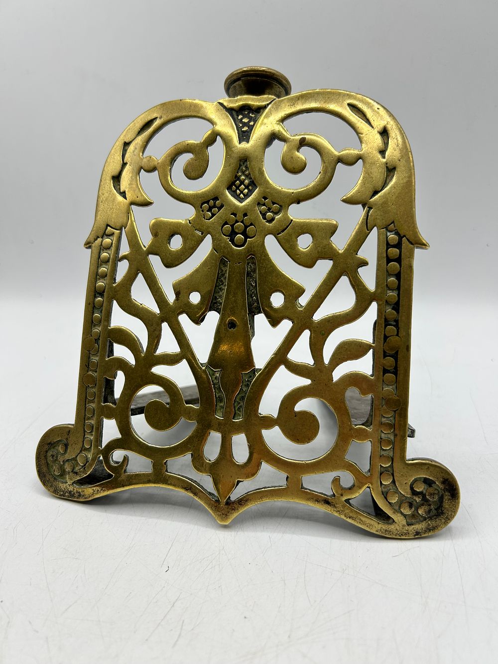 Lot 430: An Antique Brass and Iron Adjustable Fireplace Trivet