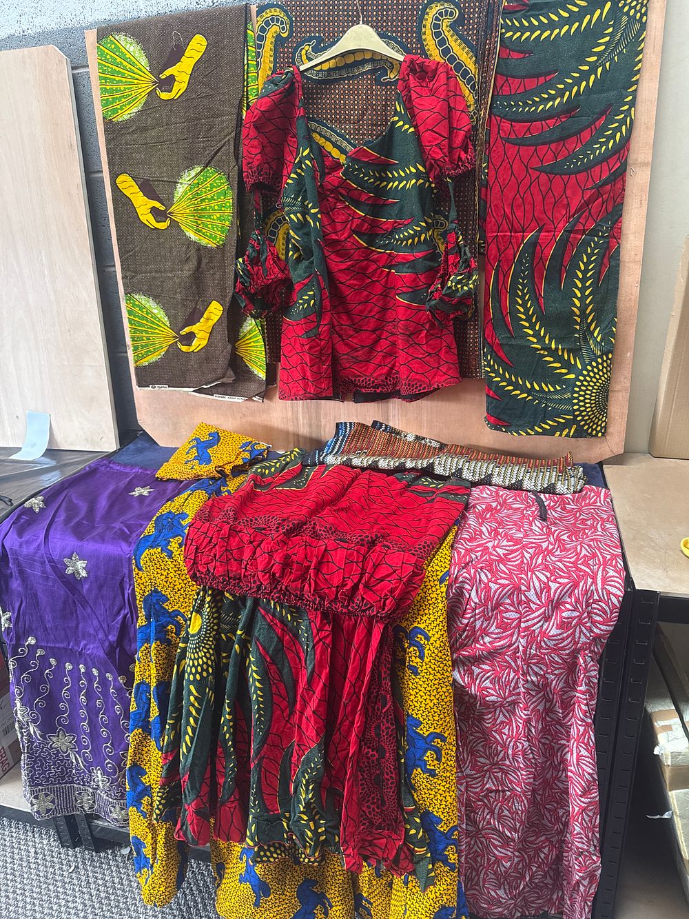 Lot 440: A Collection of African Ankara Dashiki Print Clothing and Fabric including One Full Outfit and Skirts