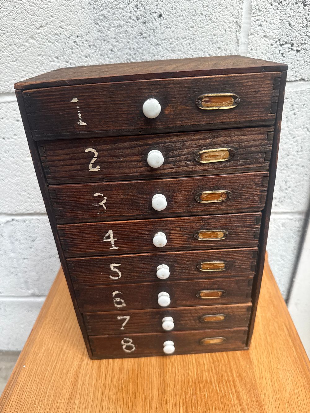 Lot 468: A Vintage Dark-Stained Wooden Eight-Drawer Spice or Apothecary Cabinet