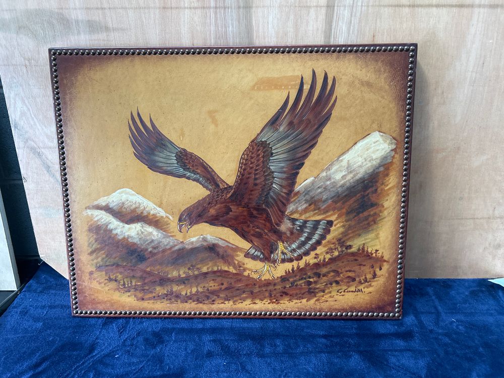 Lot 498: A vintage painting/poker work on leather depicting an eagle in flight signed G. Gandill