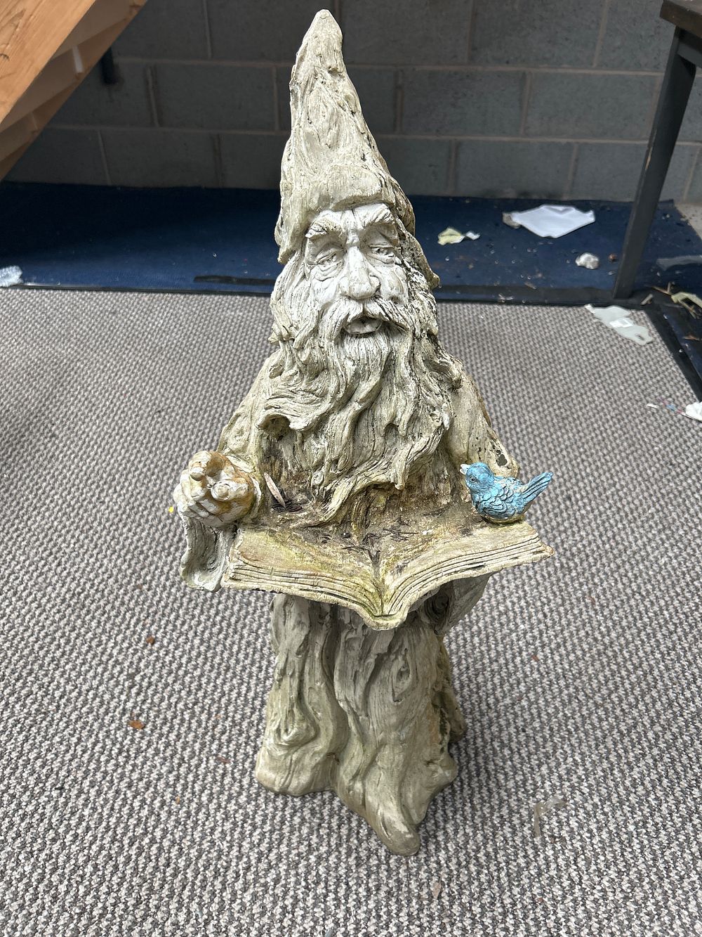 Lot 421: A Large Resin Garden Statue of a Wizard holding a Book and Bird