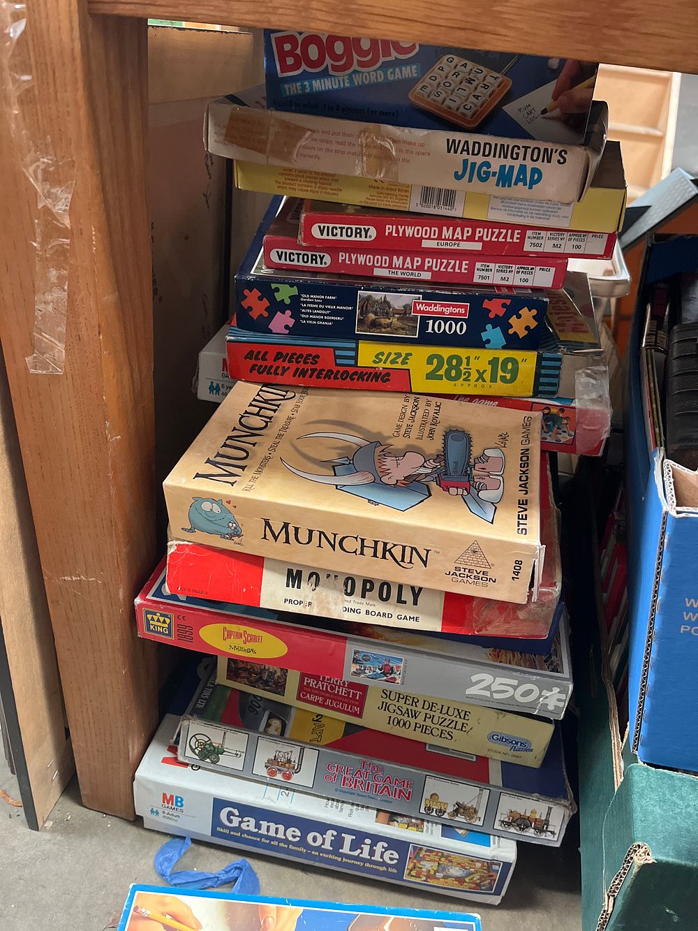 Lot 451: A Collection of Vintage Board Games and Jigsaw Puzzles including Munchkin, Monopoly, and Boggle