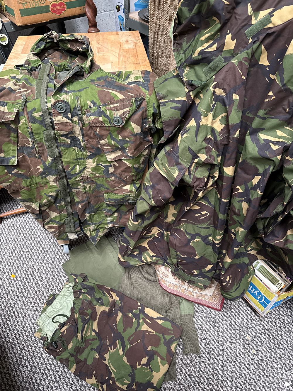 Lot 541: A Collection of British Army DPM Camouflage Clothing comprising Two Jackets, Two Trousers, and One Jumper