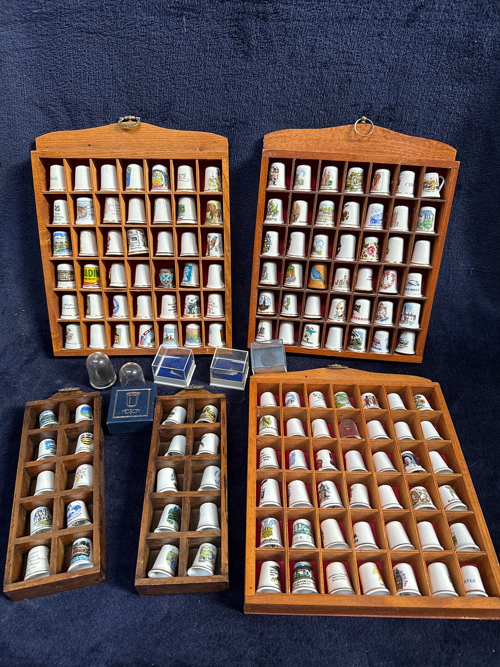 Lot 544: A Collection of Porcelain and Bone China Souvenir Thimbles with Wooden Display Cases
