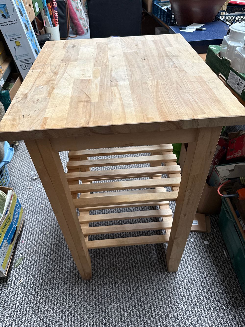 Lot 579: A contemporary natural wood kitchen utility table with slatted shelf