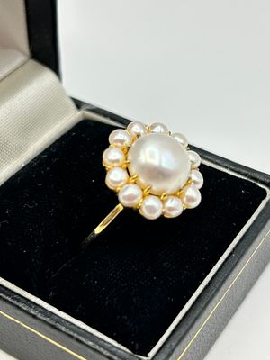 A silver and pearl cluster cocktail ring